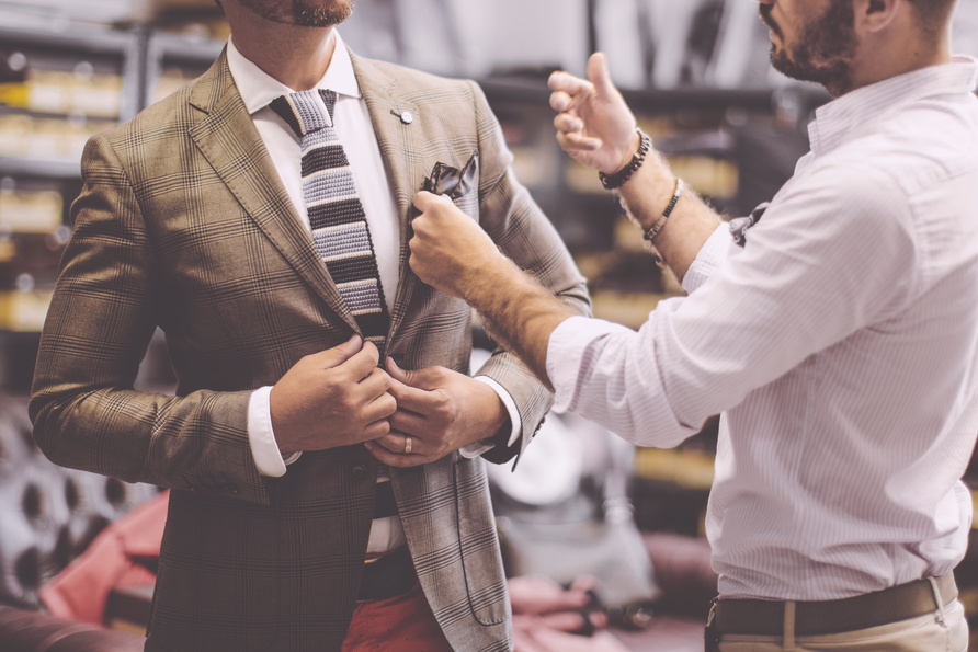 A personal stylist helping his customer